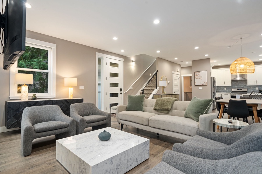 Sink into plush seating and unwind in your sophisticated living space with modern amenities and warm lighting throughout.