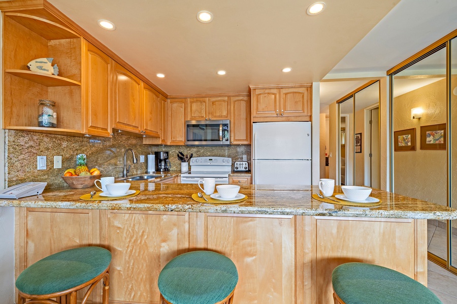 The kitchen's breakfast bar provides a casual dining space, perfect for enjoying a quick bite or morning coffee before starting your day.