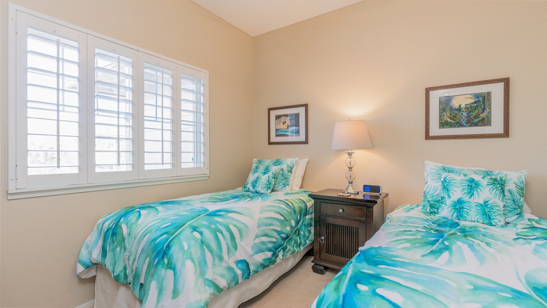 The third guest bedroom with twin beds and a dresser.