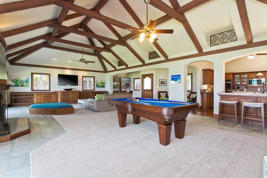 Play, relax, and entertain in a spacious game room that opens up to the beauty of the beachfront.