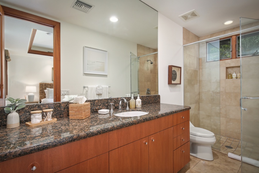 Guest Suite #4’s en suite bath with large vanity and glass enclosed shower.
