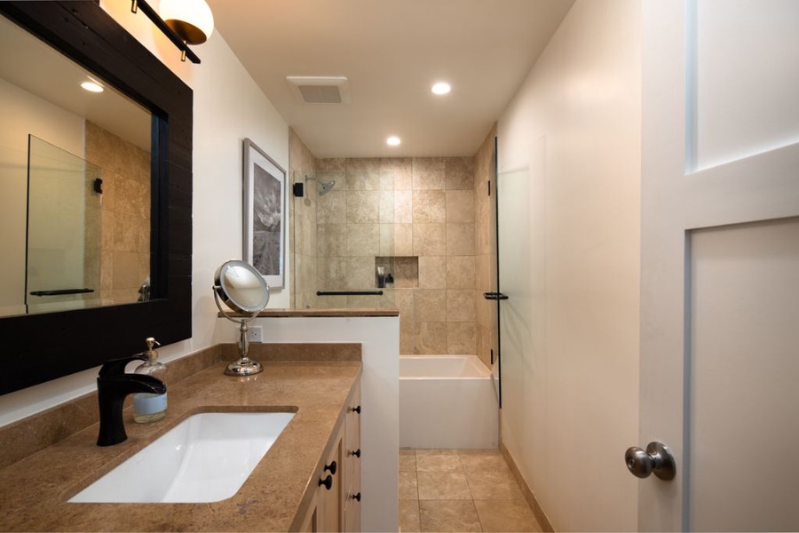 Ensuite bathroom features storage and shower_tub combo.