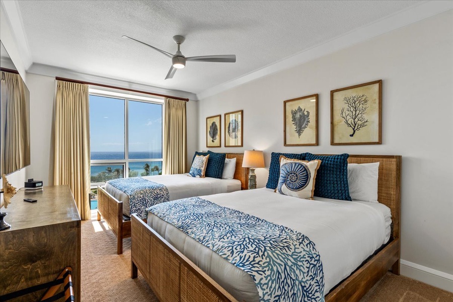 Stylish room at Honua Kai Hokulani 825 with two queen beds and stunning ocean views.
