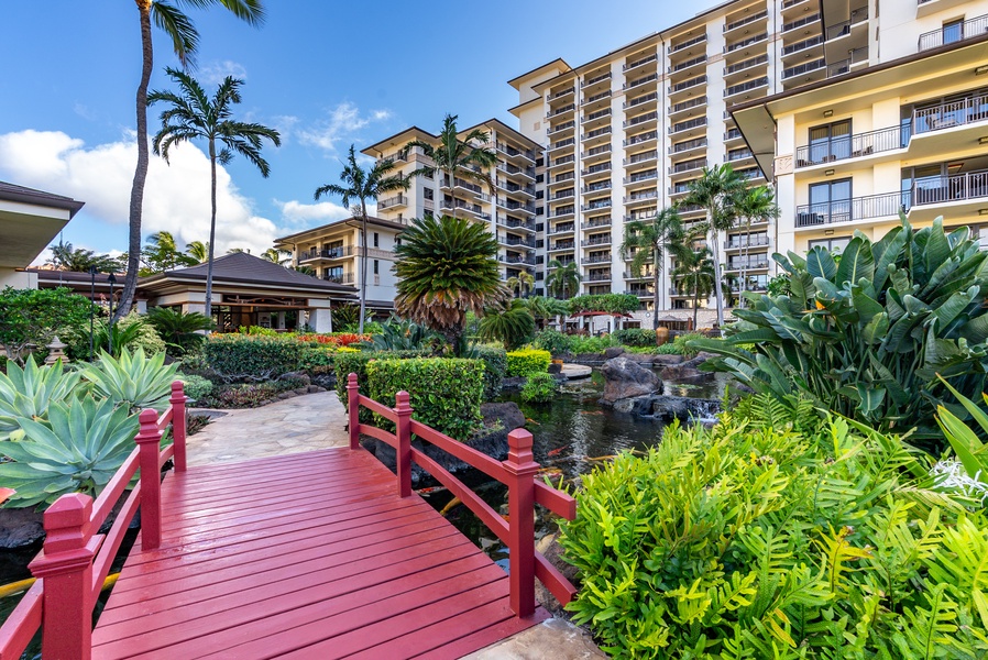 The red footbridge arches over the koi pond, part of the walk to the beach.