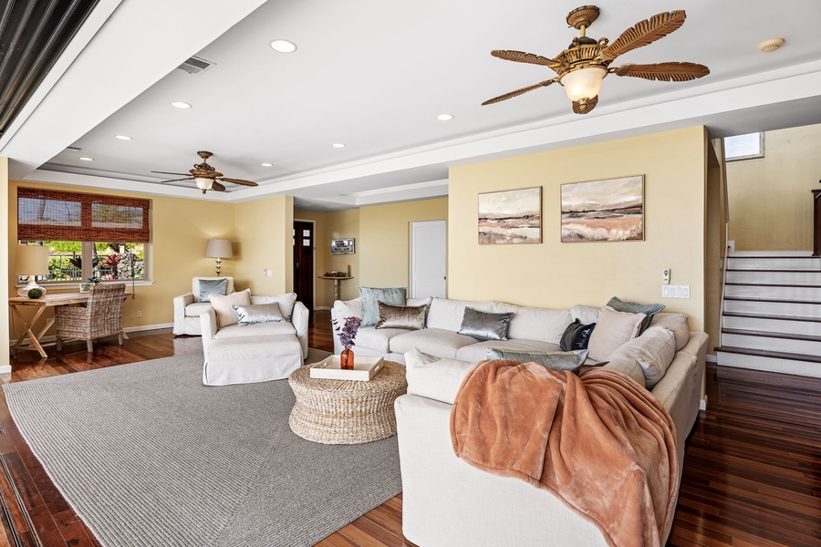 Cozy living area featuring tasteful décor and ceiling fans for added comfort.