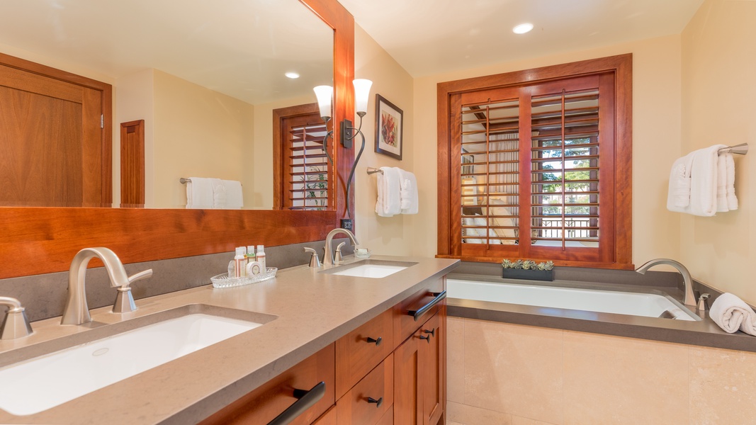The primary guest bathroom has a soaking tub to relax and unwind.
