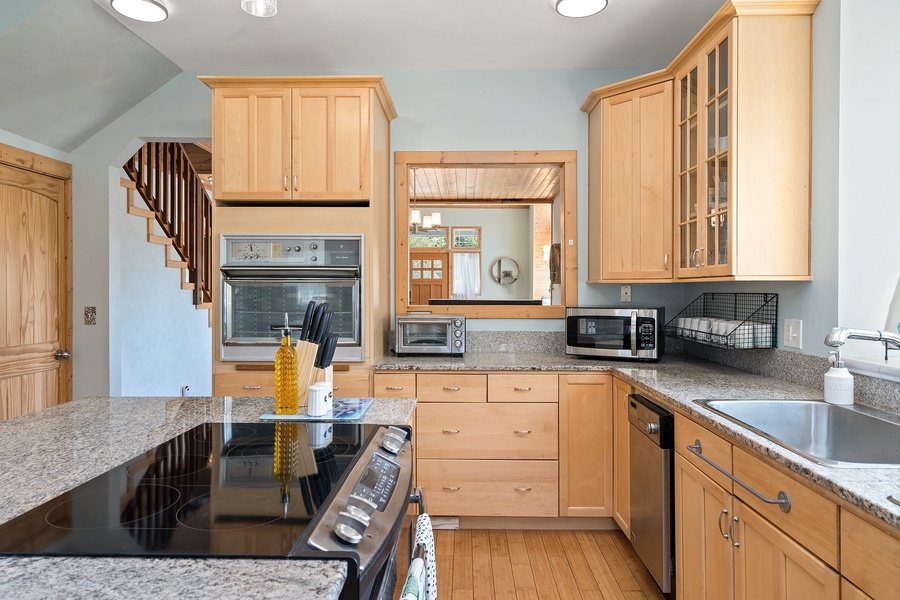 Fully-equipped home kitchen featuring a countertop induction cooker and microwave