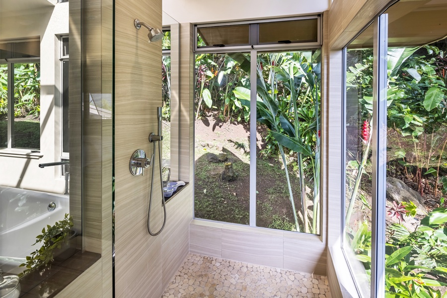 Tropical garden views from the spa-inspired shower—connect with nature as you refresh and unwind.