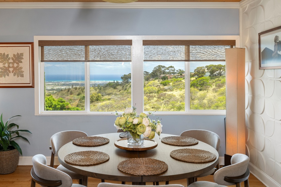 Gather around a round dining table with wraparound windows offering ocean and hillside views—a daily reminder of paradise.