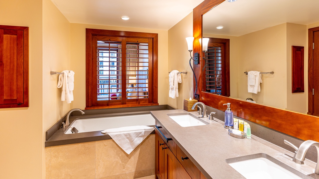The primary guest bathroom featuring a luxurious soaking tub.