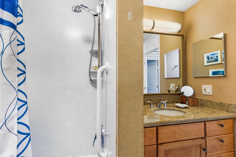 A shower and vanity area, providing a practical and comfortable space to refresh and prepare for your day.