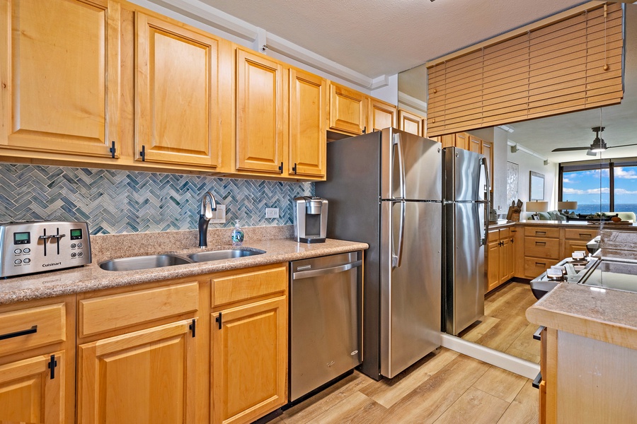 The kitchen features warm wooden cabinetry paired with modern stainless steel appliances.