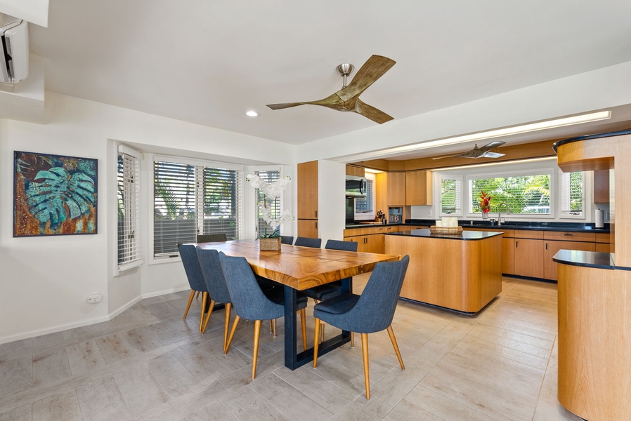 The dining area next to the kitchen offers a modern space for family meals.