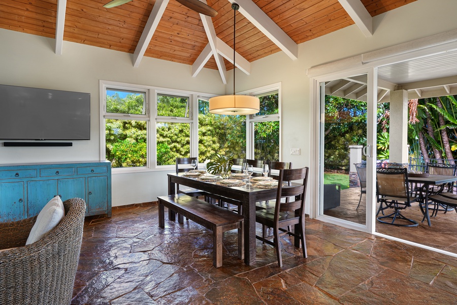 Your dining space features warm wood beams, tropical garden views, and seamless patio access for memorable meals.