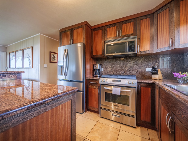 Fully-stocked kitchen with stainless steel appliances.