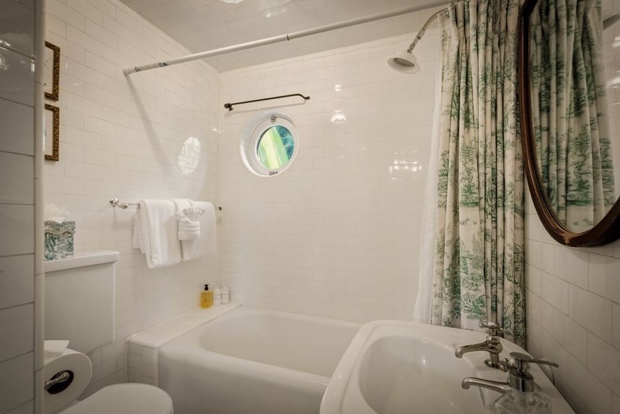 Soak in your private tub with charming porthole views and fresh towels at hand for ultimate relaxation.