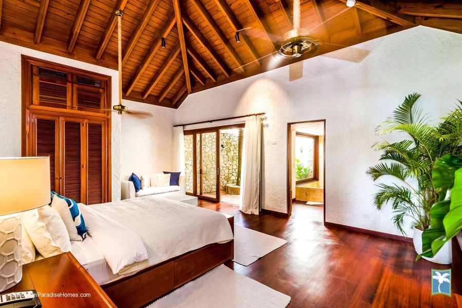 Bright and airy guest bedroom with a private garden view.