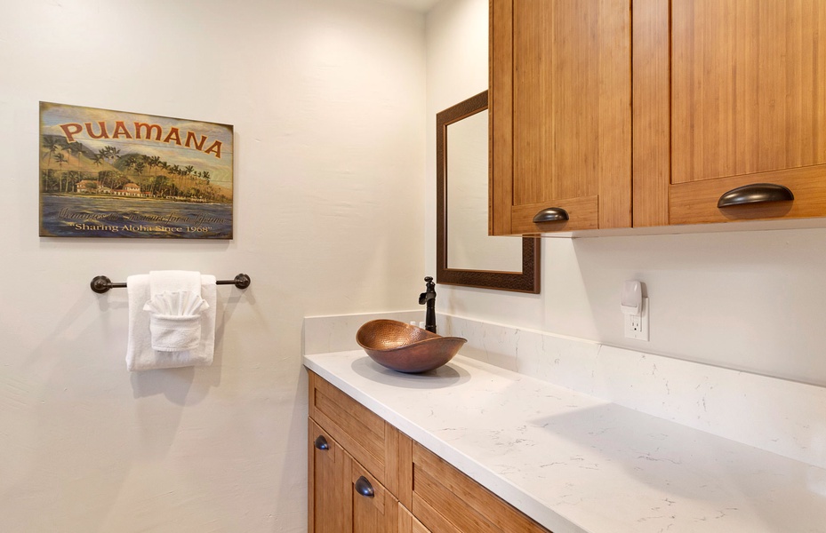 A charming bathroom with modern fixtures and a touch of natural wood accents.