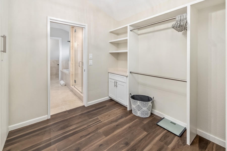 Spacious walk-in closet with built-in storage and easy bathroom access.