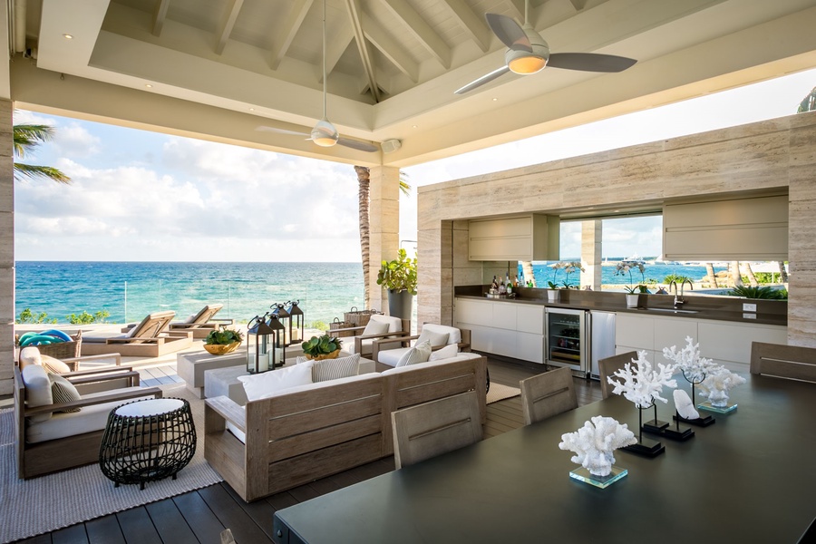 Bask in the open-air living area with cozy seating and stunning ocean views.