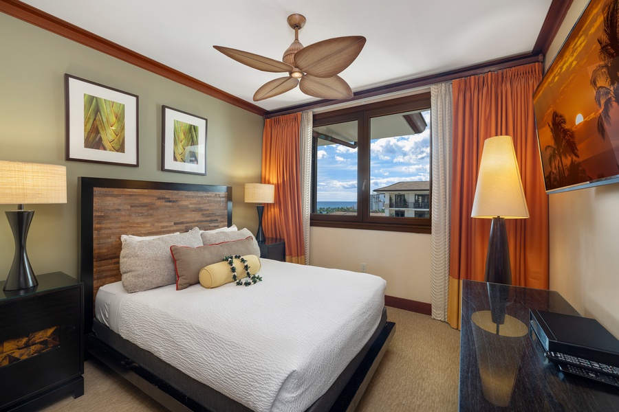 The second guest bedroom has a queen bed and a view.