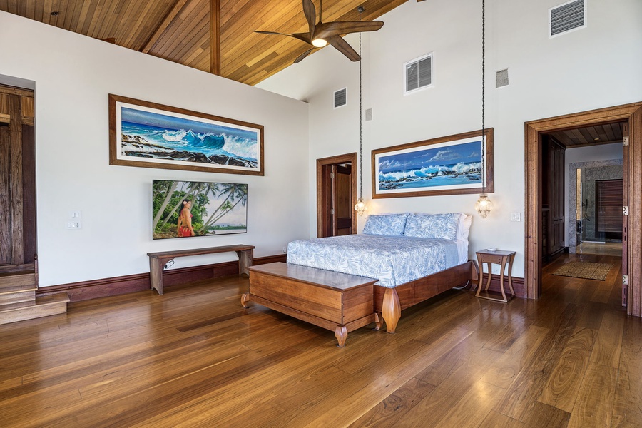 Drift off beneath vaulted wood ceilings in your elegant island retreat, where ocean artwork and warm hardwoods create your perfect sanctuary.