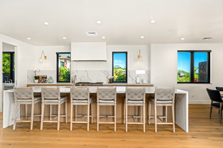 Gather around this stunning kitchen island where quartz countertops and woven bar stools create the perfect spot for morning coffee or evening conversations.