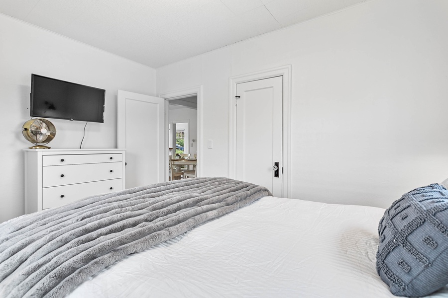 The main-level bedroom offers a queen-size bed, soft textures, and calm tones for deep rest.