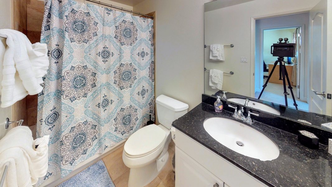 The second guest bathroom with a shower and colorful designs.