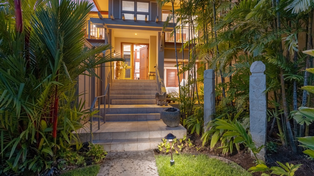 Welcoming front entrance surrounded by vibrant landscaping.