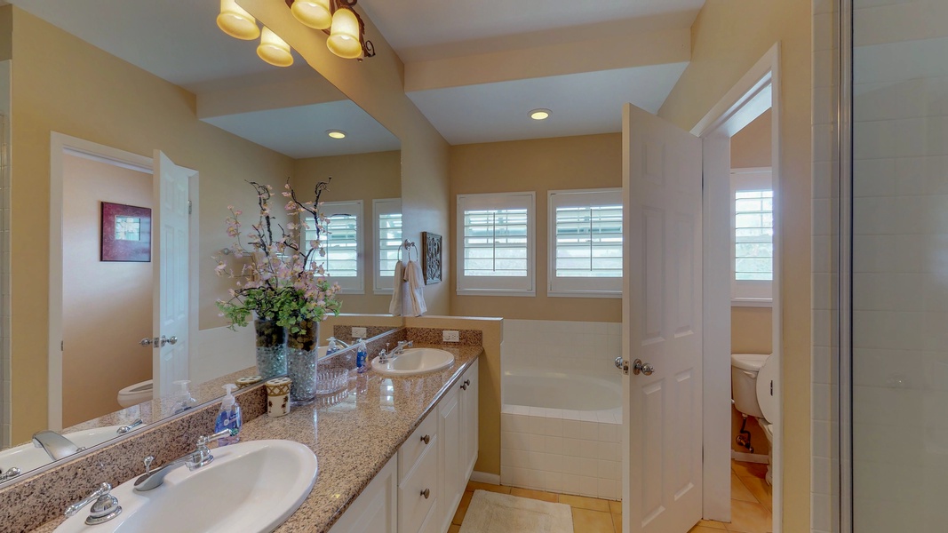 The upstairs primary guest bedroom features a shower and soaking tub.