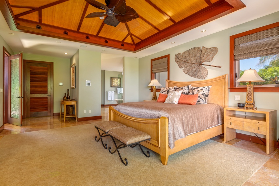 Unwind in the luxurious primary suite with a king bed, private lanai, and tropical garden access.