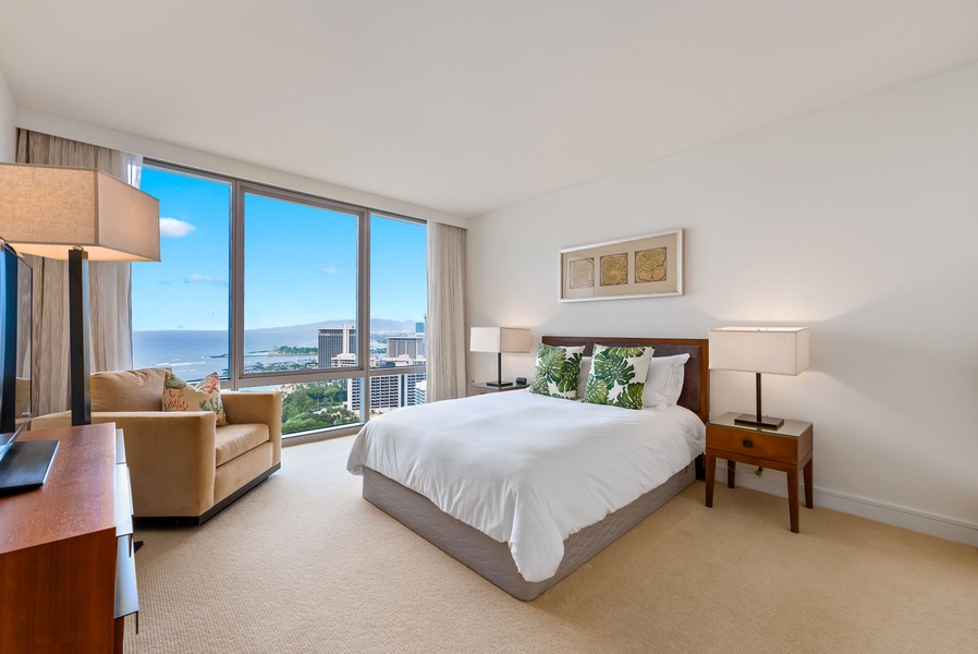 Primary bedroom with stunning floor-to-ceiling windows, offering incredible ocean views.