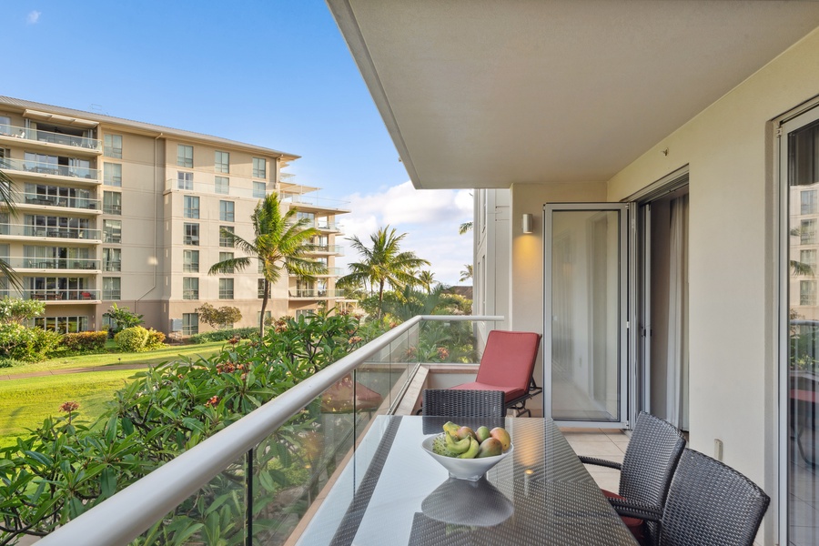Sip sunset cocktails from the shaded lanai at Honua Kai Konea 204 with partial ocean and garden views.