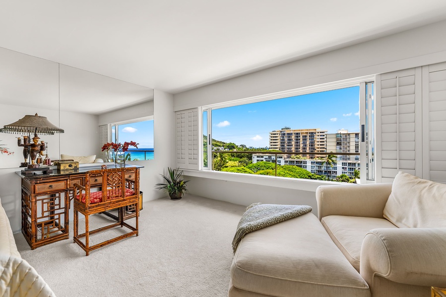 Primary bedroom with plush sofa and wide window seating, ideal for lounging or catching up on your favorite book.