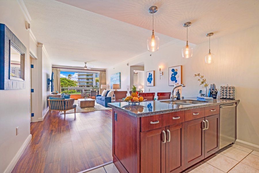 Bright, open kitchen with views into the living area and out to the lanai, perfect for prepping meals while staying connected with your group.