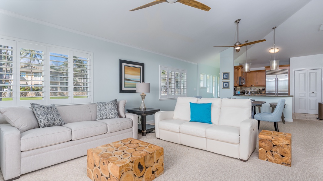 Sink into the plush seating in the living area surrounded by natural wood and ocean tones.