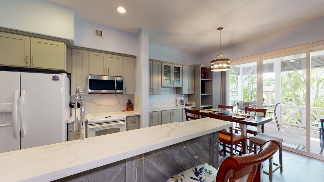 The spacious kitchen with bar seating has all your needs for a relaxing vacation.