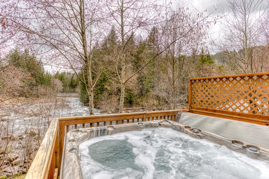 Soak in the hot tub while the river flows by