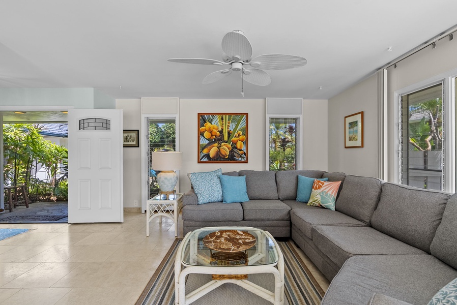 Relax in this inviting living space, where soft tones and tropical artwork create the perfect island retreat ambiance.