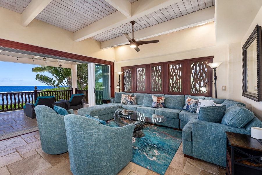 Spacious great room with tropical furnishings and seamless indoor-outdoor flow for relaxing or gathering.
