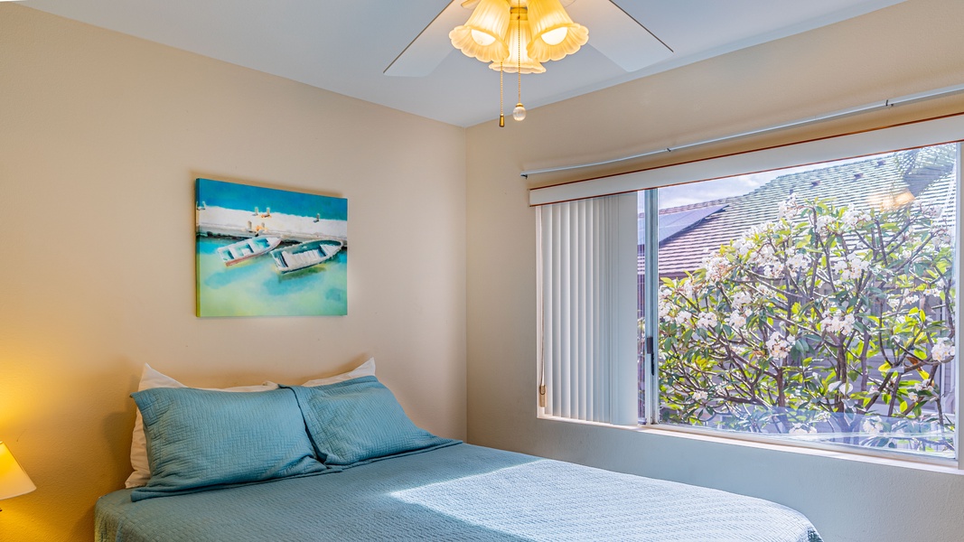 The second guest bedroom features a television and comfortable bedding.