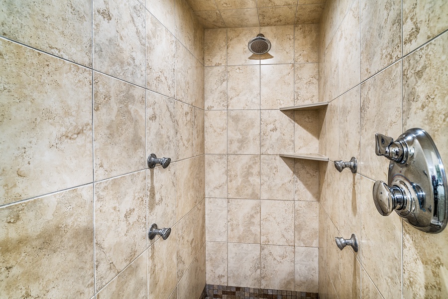 Primary bathroom shower with multiple jets