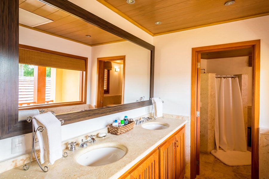 Primary ensuite bath features double sinks and a walk-in shower on the right.