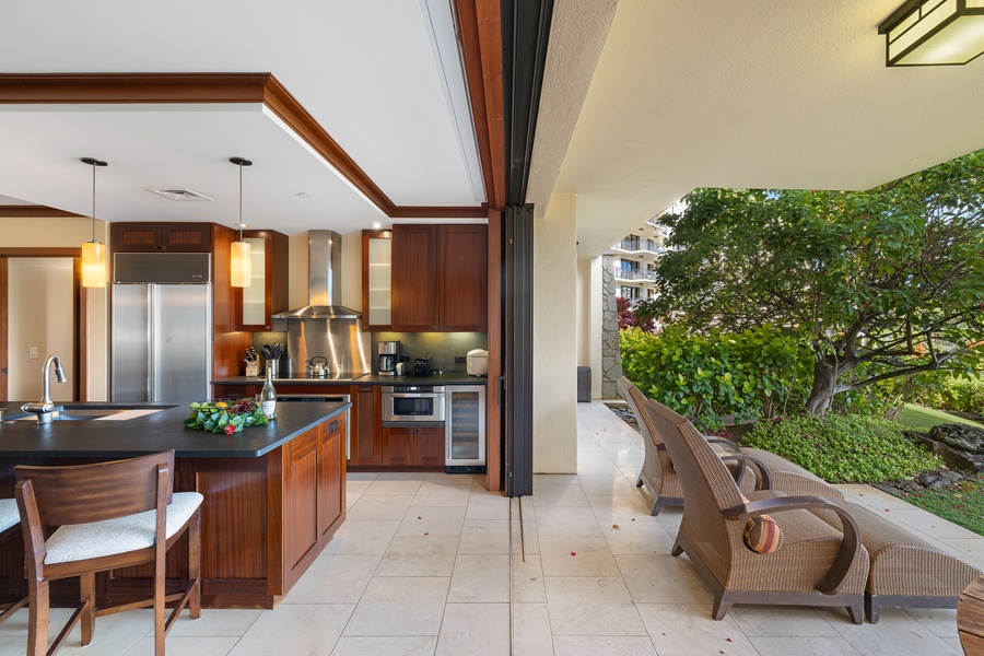 Kitchen with open patio transition, merging indoor luxury with outdoor tranquility.