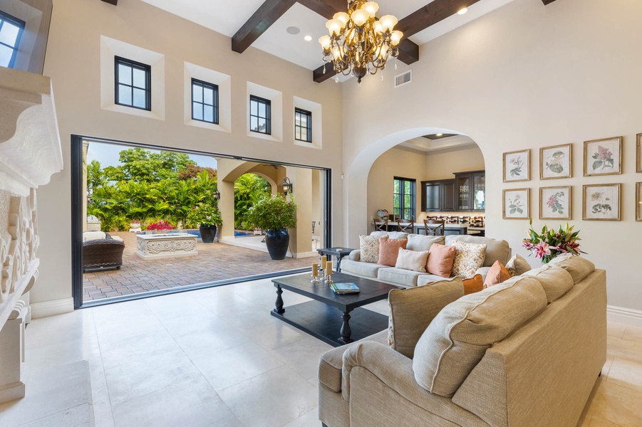 Living room opening to an outdoor patio, seamlessly blending indoor and outdoor spaces for entertaining.