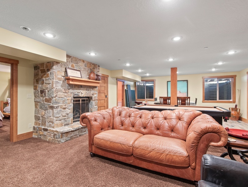 Fireside comfort at its finest_ Sink into serenity on the plush couch, embraced by the warm glow of the fireplace