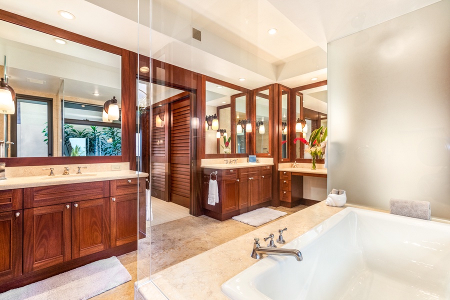 Luxurious primary bath with dual vanities, oversized soaking tub, private w/c, walk-in shower, and bonus outdoor shower garden.