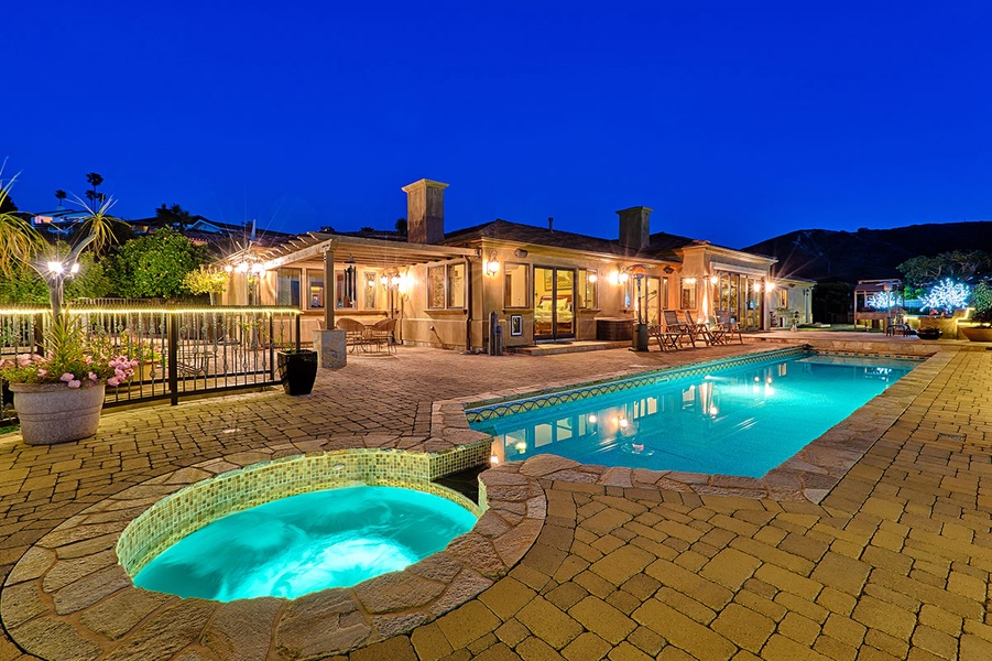Hot tub and salt water pool with ocean views, fire pit, BBQ, and plenty of outdoor lounging and dining areas.