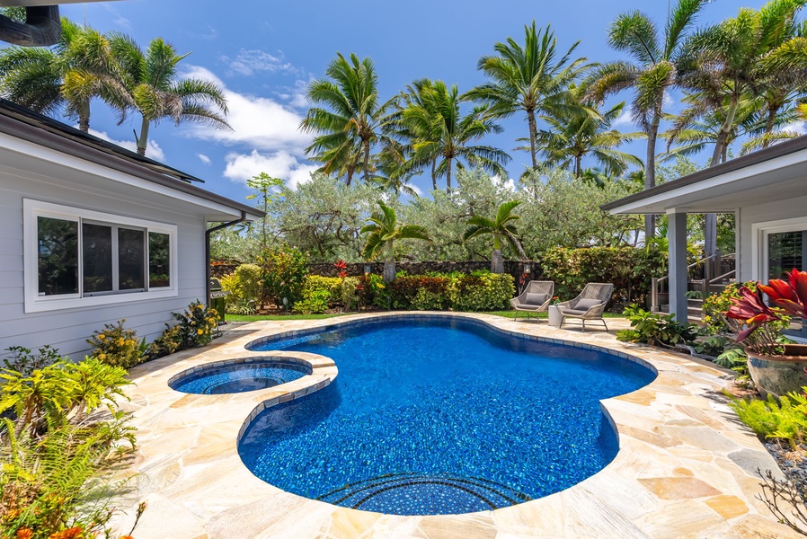 Palm trees and blue water create the perfect backyard escape.